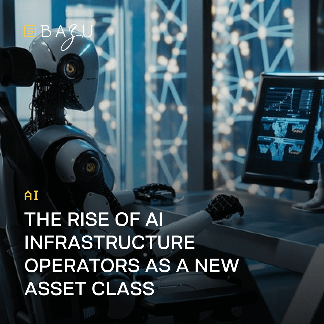 Advanced humanoid robot with glowing eye and mechanical arm seated at a high-tech workstation in a futuristic office, surrounded by floating holographic blue network nodes and multiple monitors displaying AI data charts and global visualizations, as BAZU highlights the emergence of AI infrastructure operators as a new asset class.